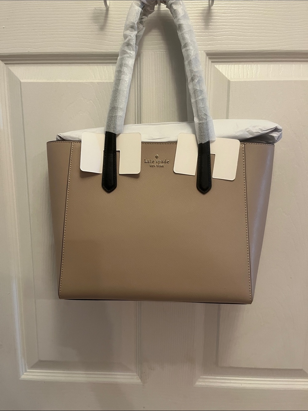kate spade warm beige tote with black handles, zipper
